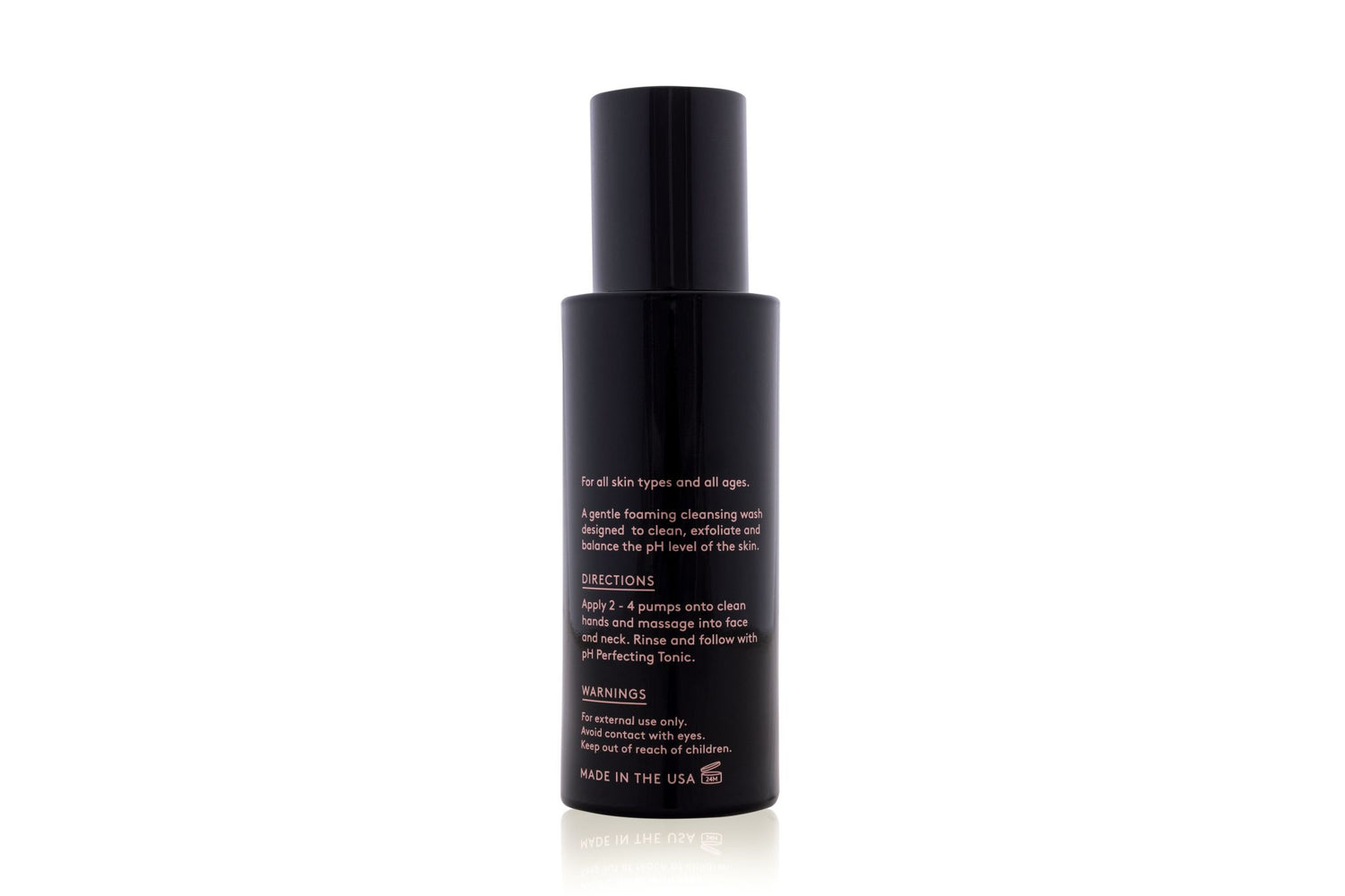 A black skincare bottle with a pump top, displaying product information on the back.