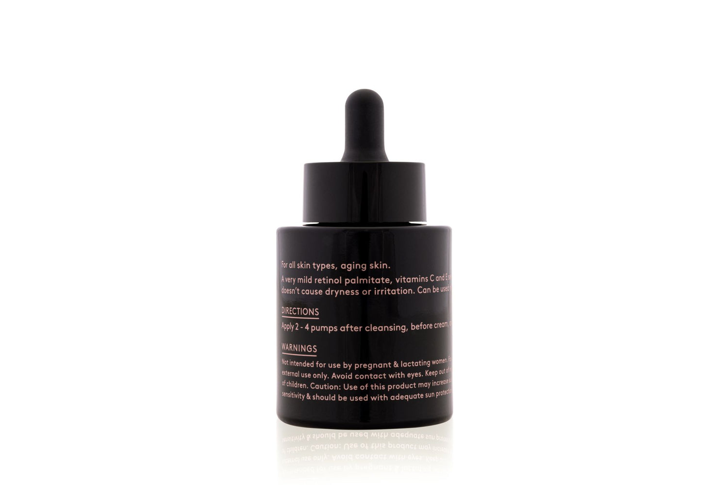A black dropper bottle containing skincare product with instructions on the label.