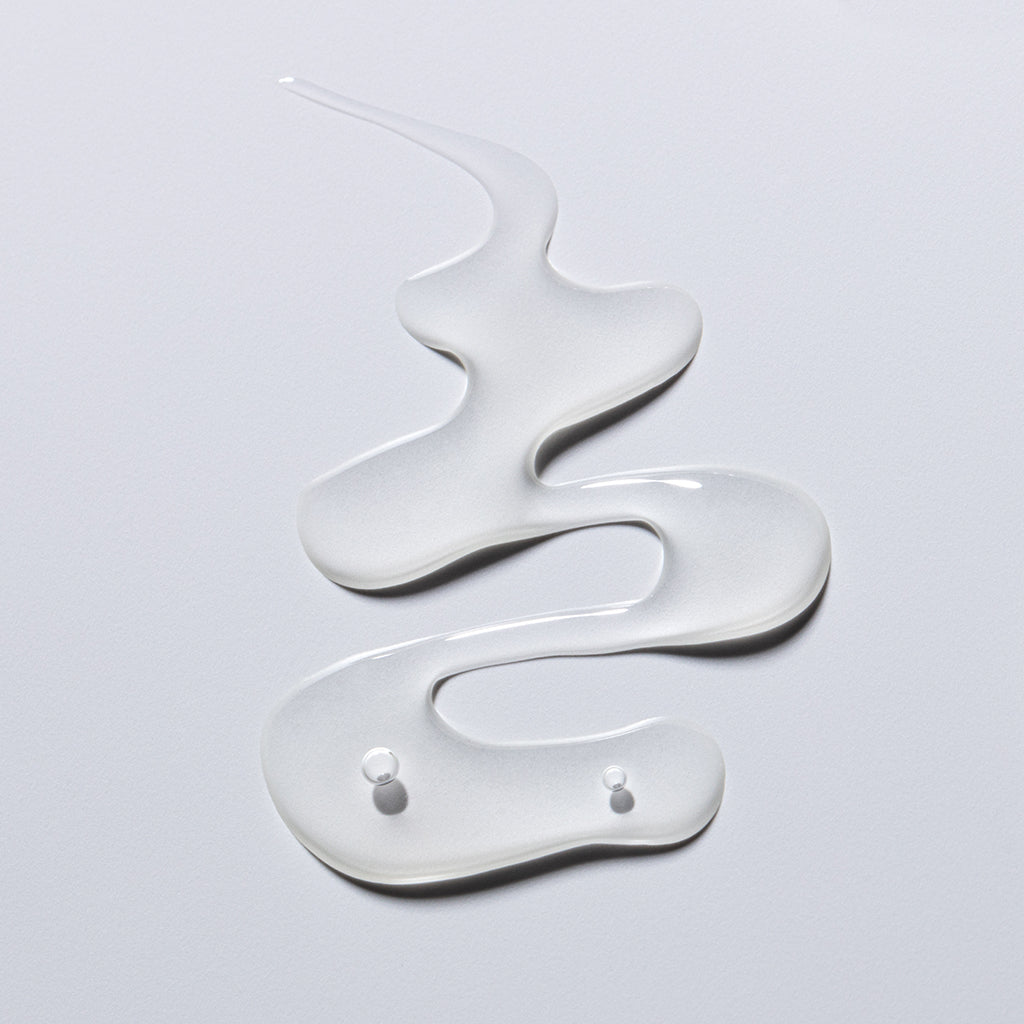 Swirls of a translucent gel on a white surface