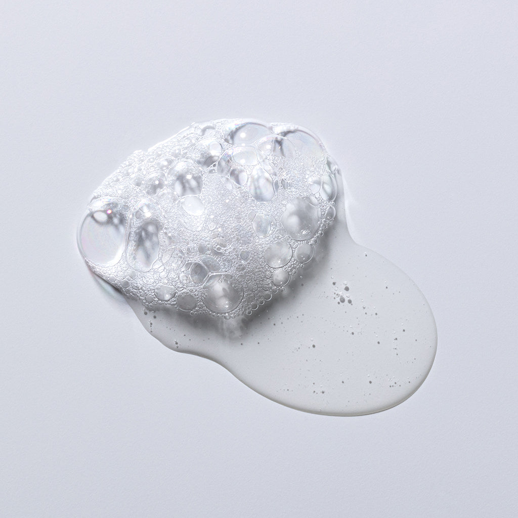 A bubble-like texture of a clear gel or liquid on a white background.