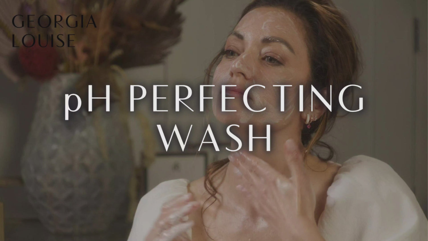 Woman applying a facial wash with text overlay &