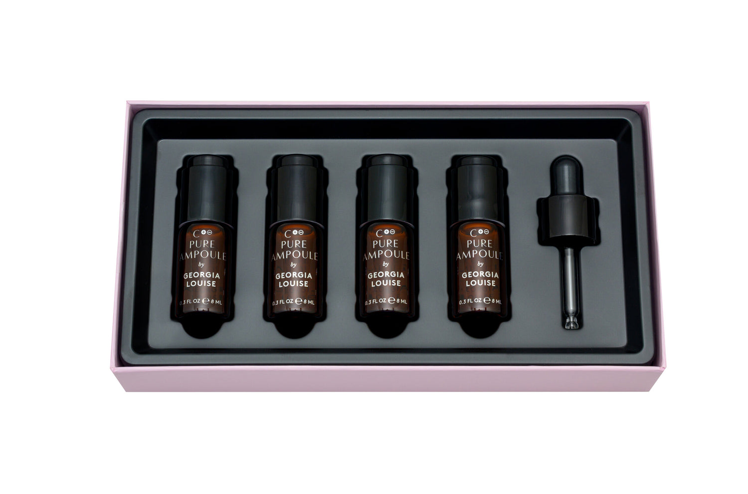 Set of four essential oil bottles with a dropper in a black tray and pink box.