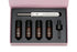 A beauty treatment kit with a microneedling pen and four serum vials in a pink box.