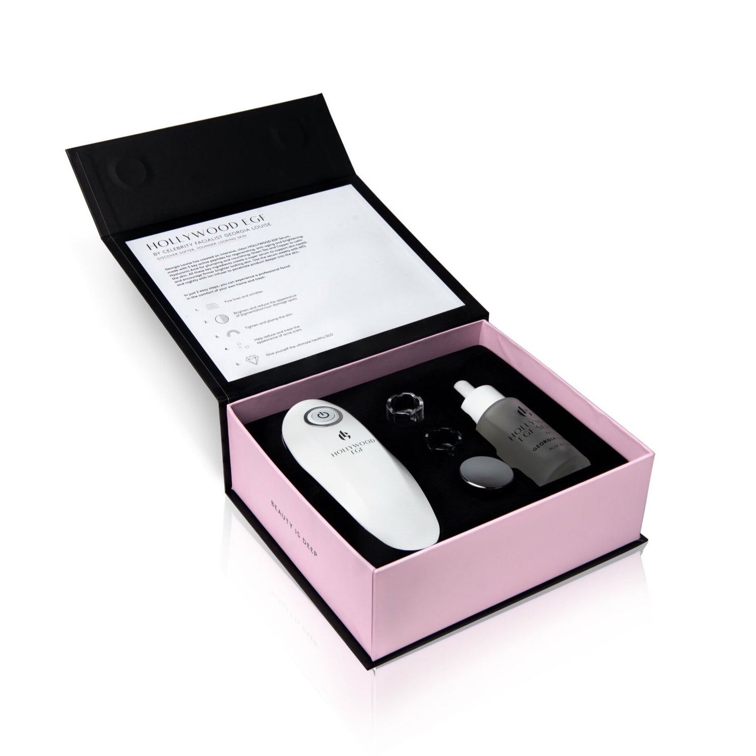 Skincare device kit arranged in a pink box with instructions and product bottles