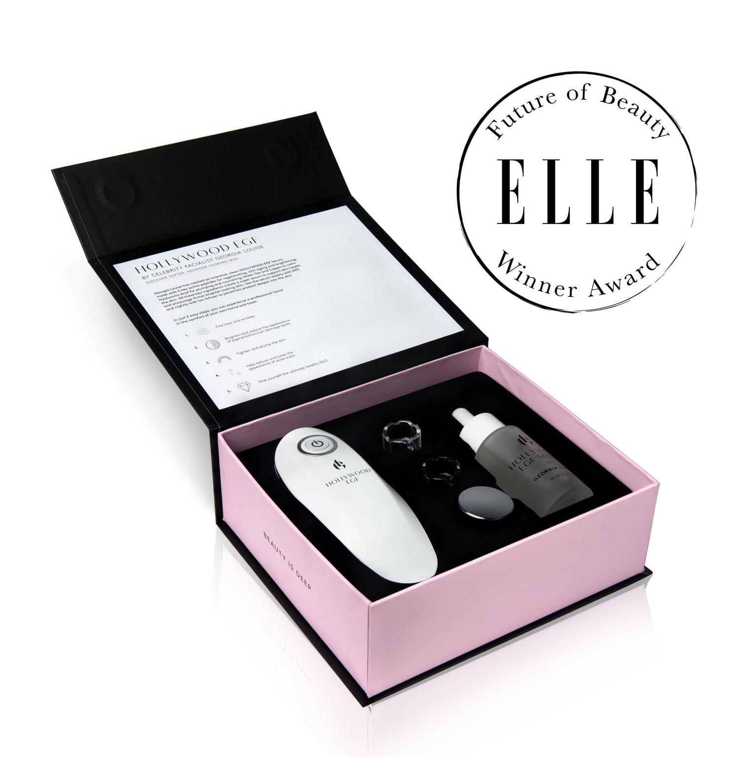 Open beauty product box including various skincare tools and a certification award.