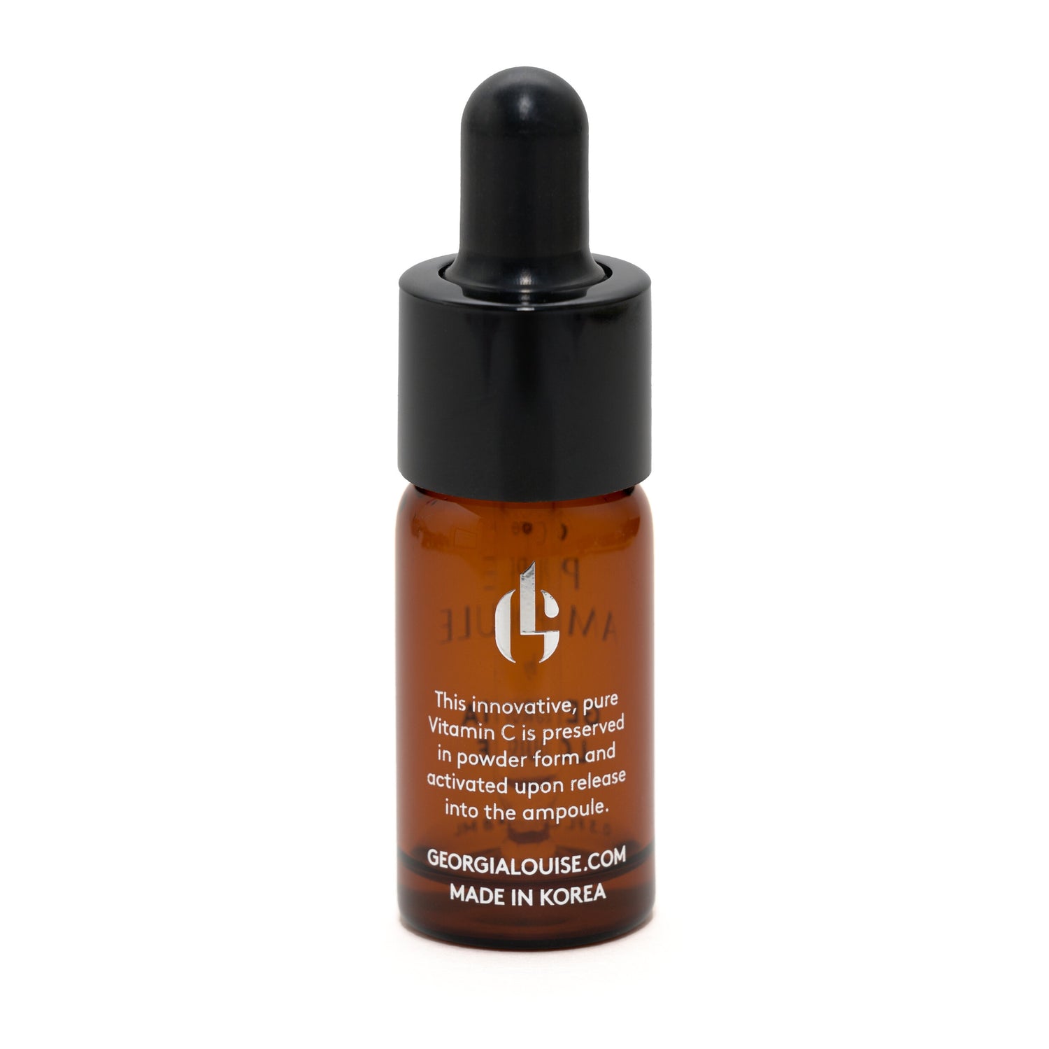 Brown glass dropper bottle with black lid, containing Vitamin C serum, labeled with product information.
