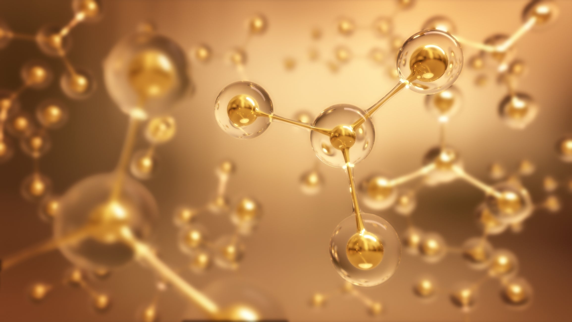 Close-up of a molecular structure with gold atoms on a warm brown background