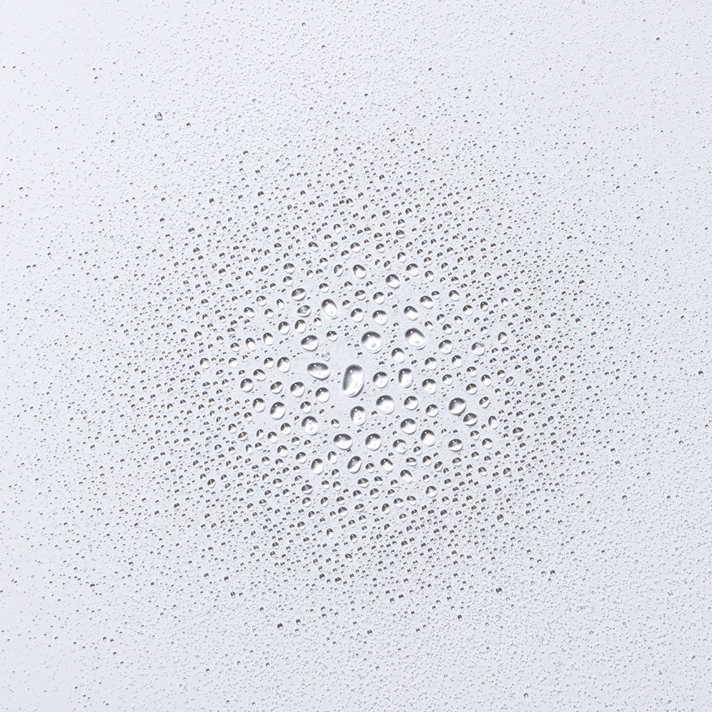 Close-up of water droplets on a white surface.